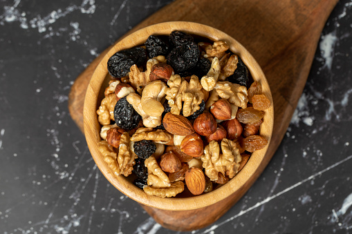 Mixed raw nuts. Special mixed nuts in bowl. Hazelnut, almond, cashew, pistachio, dried blueberry. Superfood. Vegetarian food concept. healthy snacks. Top view