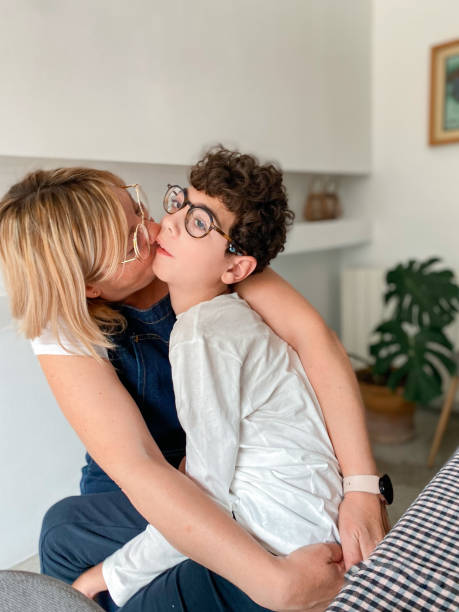 Loving mother with disabled son sitting on top