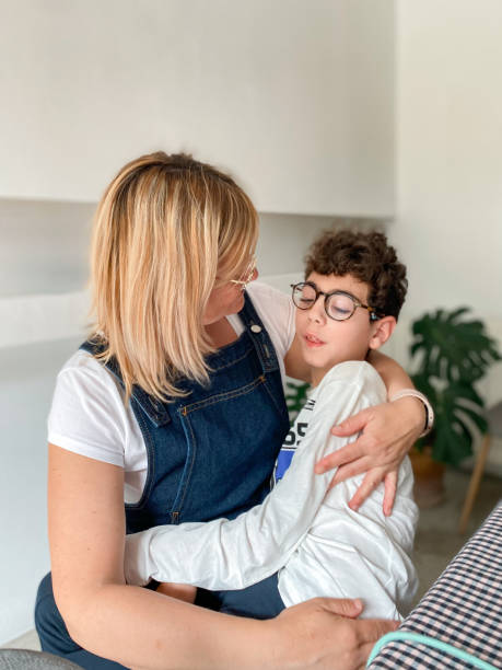 Loving mother with disabled son sitting on top