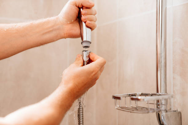 istock A master plumber collects a shower head in the bathroom. 1490298817