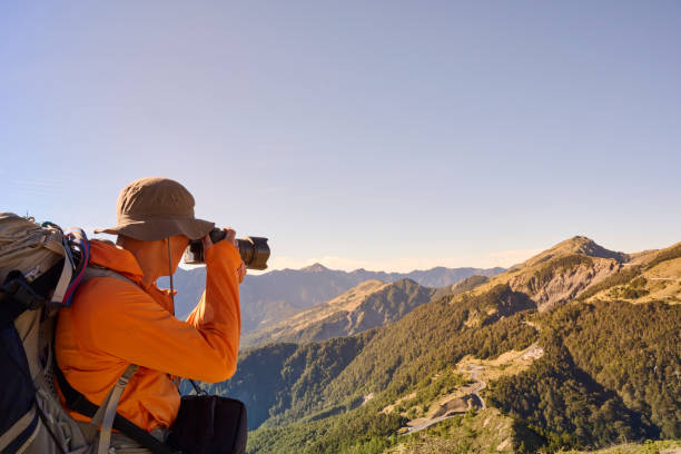 Mountain hiker taking photos on the mountain top.