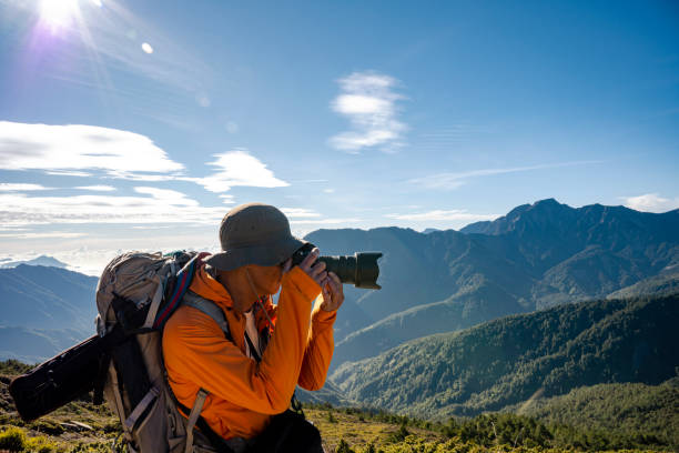 istock Mountain hiker taking photos on the mountain top. 1490299276