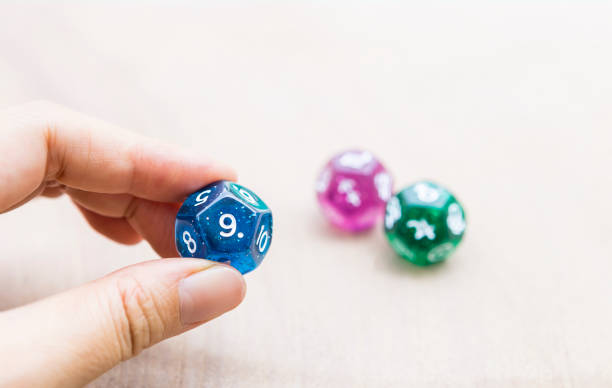 istock Numerology dice in girl hand over blurred background 1490299322