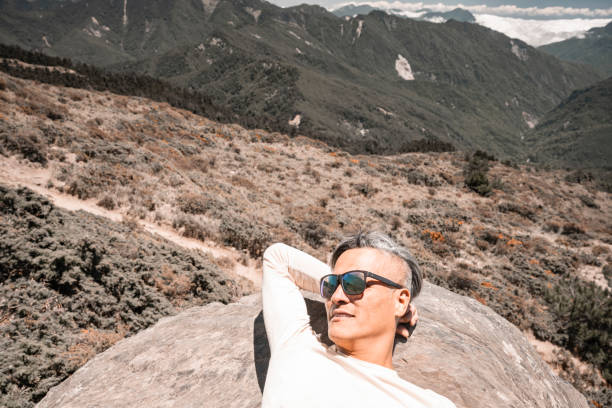 istock A mountain guide take a rest on the mountain top. 1490300052