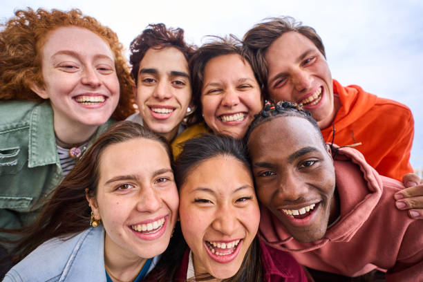 istock Multi-ethnic group smiling student boys and girls taking selfie outdoors. People enjoying weekend. 1490301163