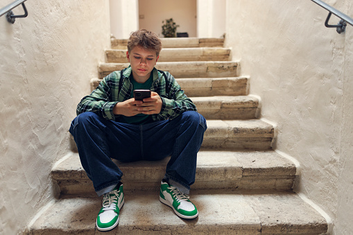 Generation z teenager sitting on stairs and using phone
Shot with Canon R5