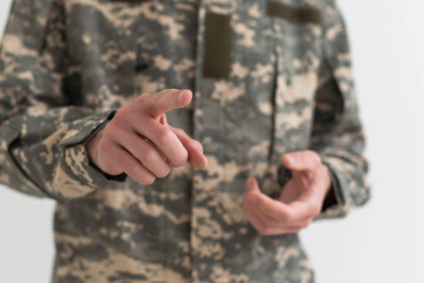 istock man wearing camouflage army uniform pointing finger to the camera with hand 1490303032