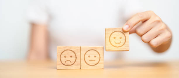 istock Hand choosing smile face from Emotion block for customer review, good experience, positive feedback, satisfaction, survey, evaluation, assessment, mood and world mental health day concept 1490304473