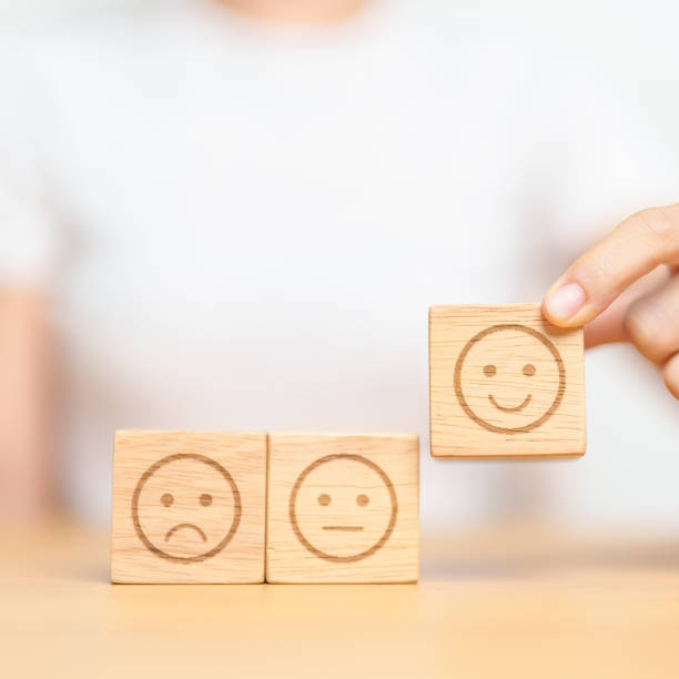 istock Hand choosing smile face from Emotion block for customer review, good experience, positive feedback, satisfaction, survey, evaluation, assessment, mood and world mental health day concept 1490304491