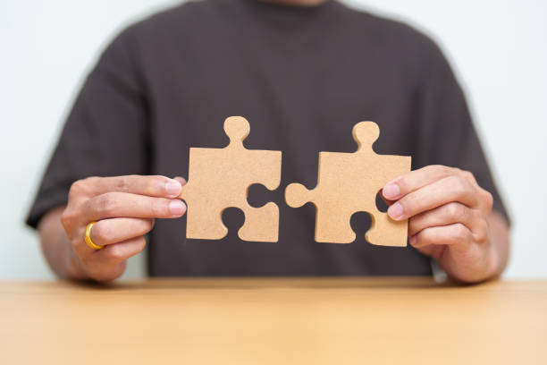 istock Hand connecting couple puzzle piece. Business Solving, mission, challenge, success, goals, target and strategy concepts 1490304731