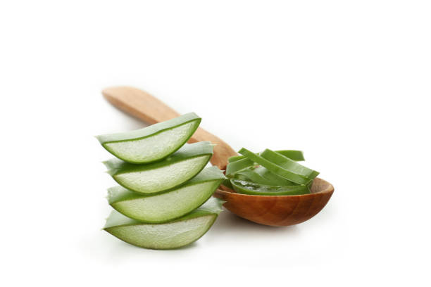 istock Spoon with aloe slices isolated on white background 1490306087