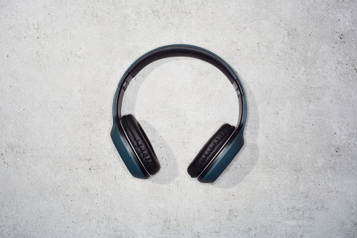 Earphones on the gray background, digital audio accessory