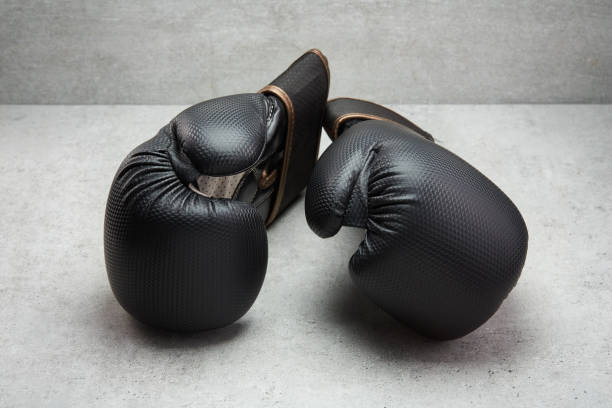istock Pair of boxing gloves on concrete background 1490306432