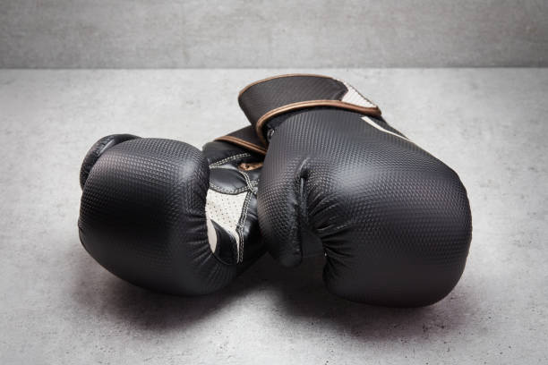 istock Pair of boxing gloves on concrete background 1490306483