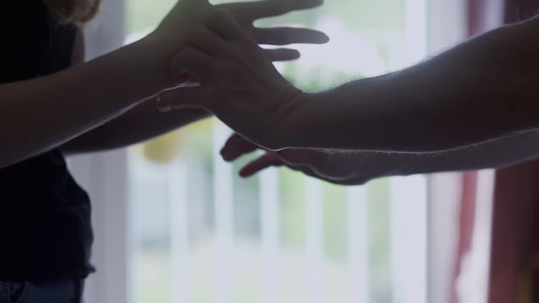 The couple is arguing. Close-up of women's and men's hands.