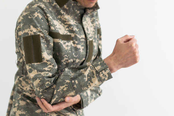 istock A military man has a pain in his arm. 1490310680
