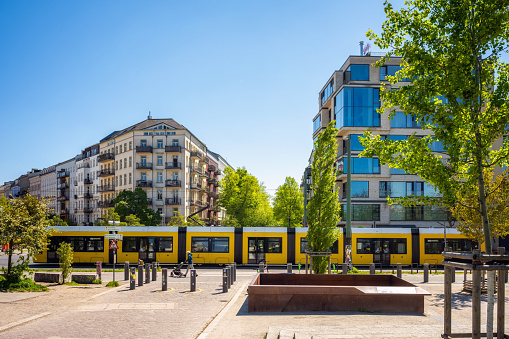 yellow street car passing Mauerpark in Berlin at sunny day