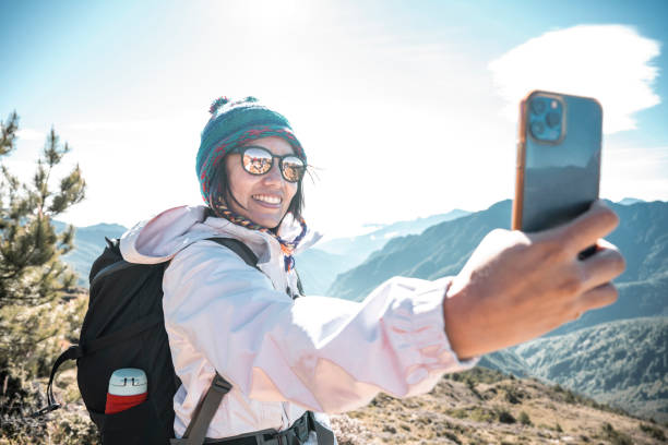 istock Friends with backpack taking selfie portrait on a mountain. 1490312953