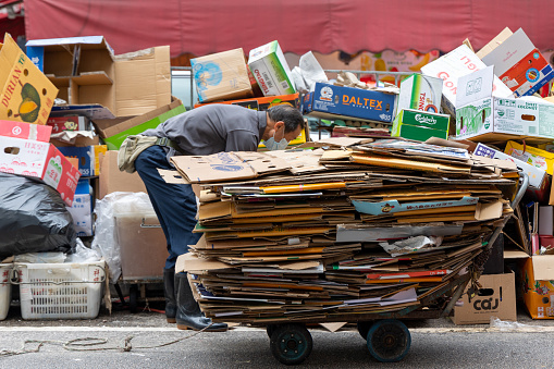 Hong Kong - May 15, 2023 : Cardboard collector picks up discarded packing boxes in Hung Hom, Kowloon, Hong Kong.
