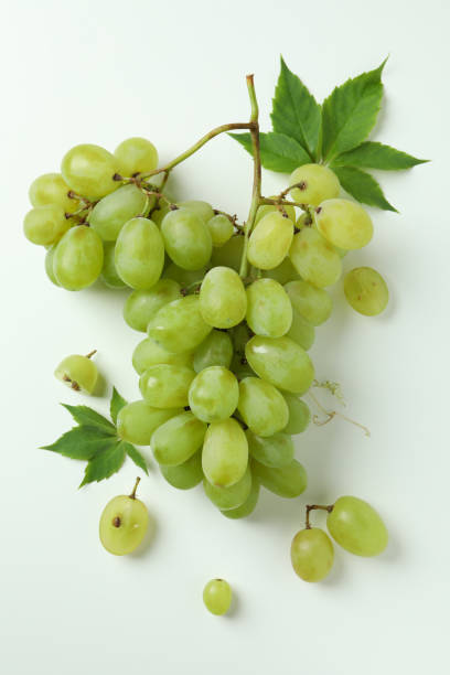 istock Green ripe grape with leaves on white background 1490313664