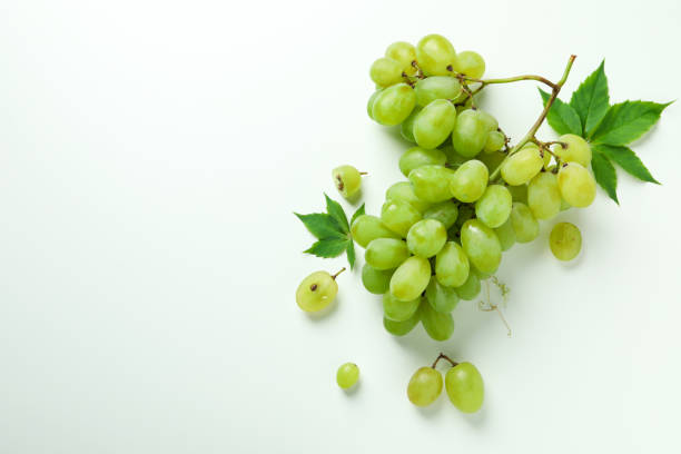istock Green ripe grape with leaves on white background 1490313942