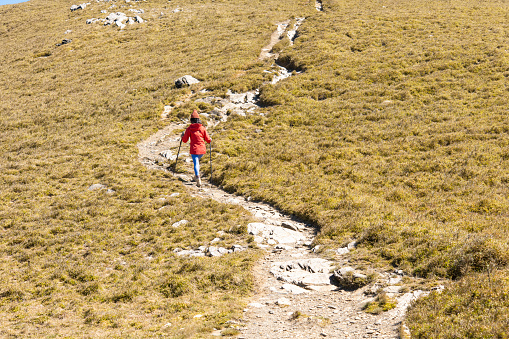 Hikers walking alone on top of a mountain.