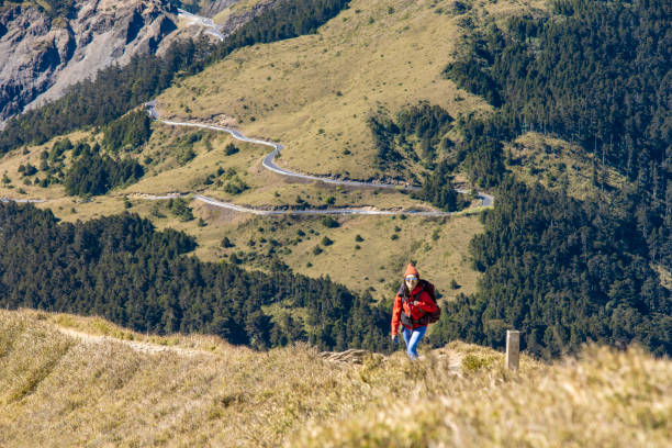 Hikers walking alone on top of a mountain.