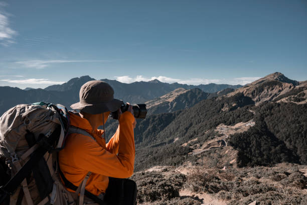 istock Mountain hiker taking photos on the mountain top. 1490314734