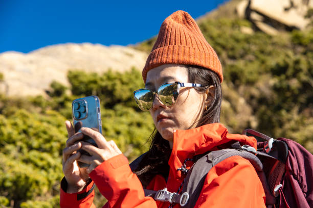 istock Mountain hiker using Ssmart phone on the mountain top. 1490314842
