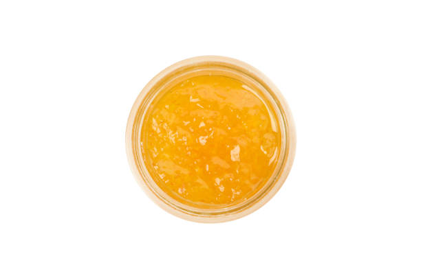 istock Glass bowl of mandarin jam isolated on white background 1490317529