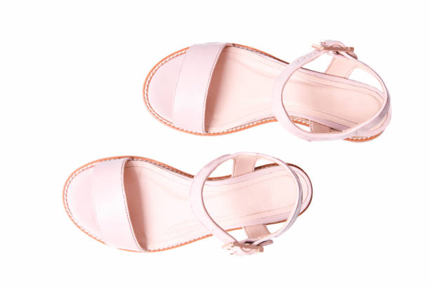 Leather beige female sandals isolated on white background.