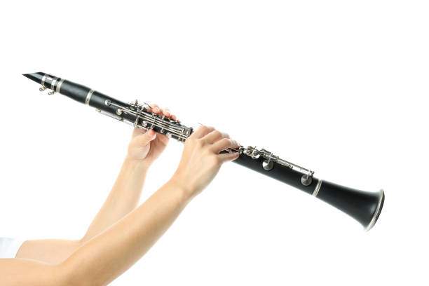 istock Female hands hold clarinet, isolated on white background 1490319762
