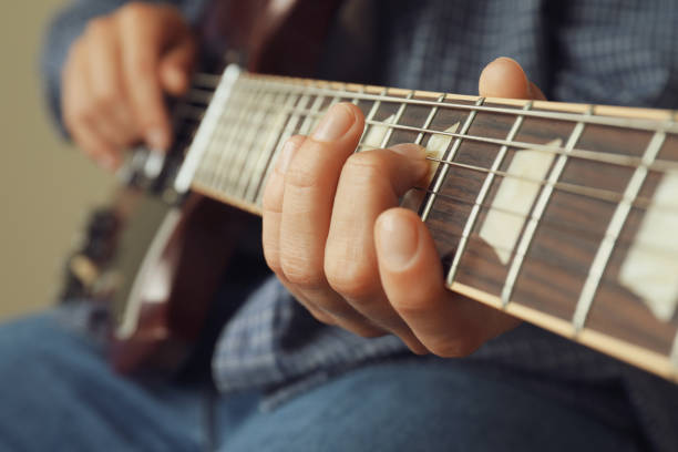 istock Musician playing on electric guitar, close up and selective focus 1490319820