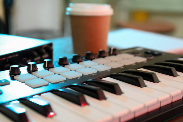 istock Musician workplace with midi keyboard, close up 1490320352