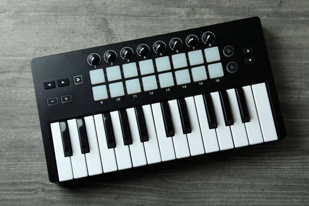istock Midi keyboard on gray textured background, top view 1490320403