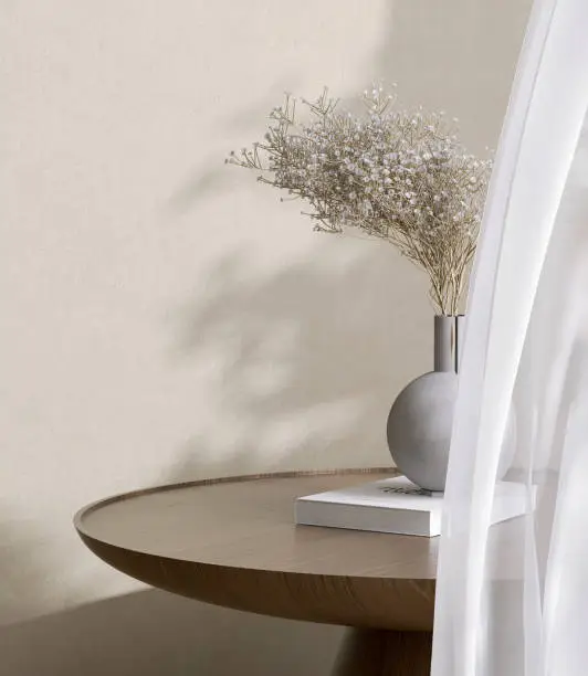 Photo of Wooden round beautiful grain podium table, flower bouquet in round vase in sunlight from white curtain window on cream concrete wall