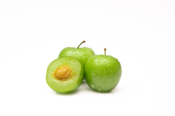 Fresh and green plum on white background