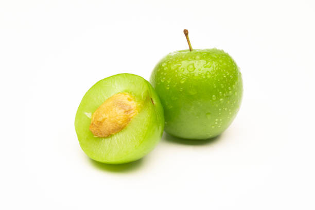 Fresh and green plum on white background