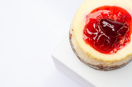 Cheese cake with raspberry on white background