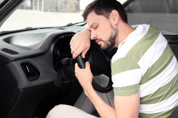 istock Tired handsome man sleeping in his modern car 1490330909