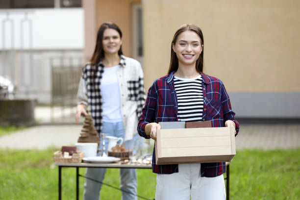 istock Women organize garage sale with different items in yard 1490331204