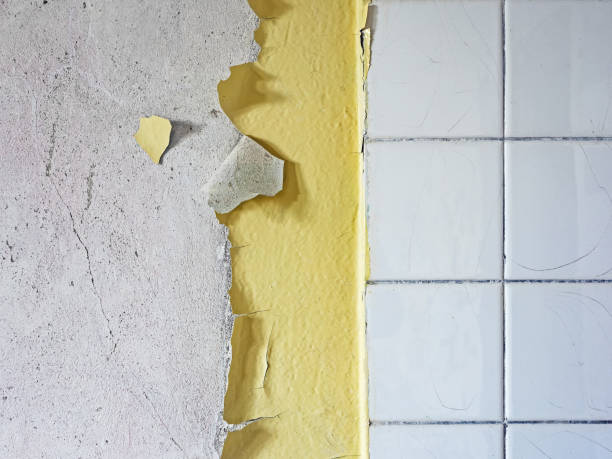istock Old wall with peeling paint and white tiles as background 1490331686