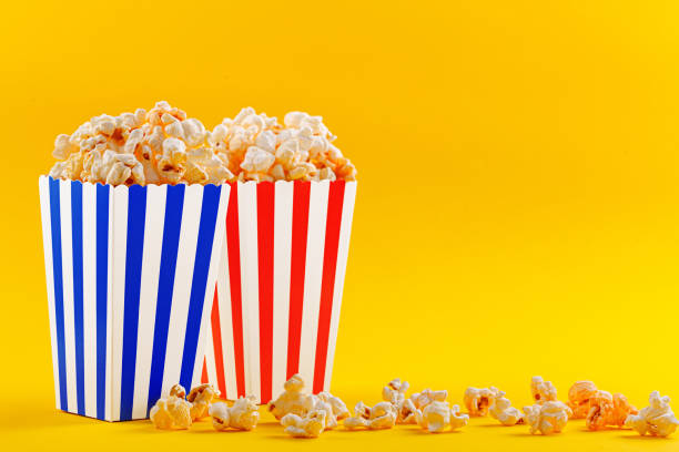 istock Glass with popcorn on a yellow background 1490332169