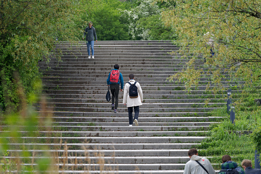 Students on the way to University Campus Irchel at City of Zürich on a cloudy spring morning. Photo taken May 9th, 2023, Zurich, Switzerland.