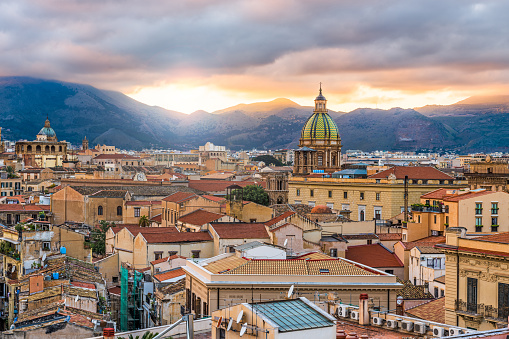 Palermo, Sicily town skyline with landmark towers at dusk.