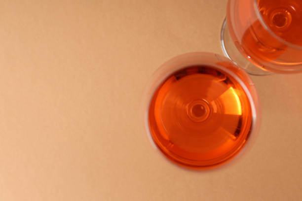istock Glasses of wine on beige background, space for text 1490338482