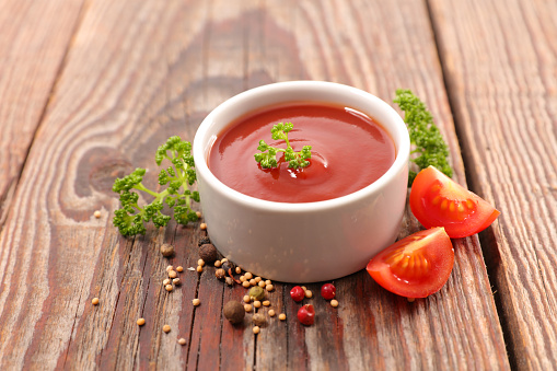 cup of tomato sauce on wood background