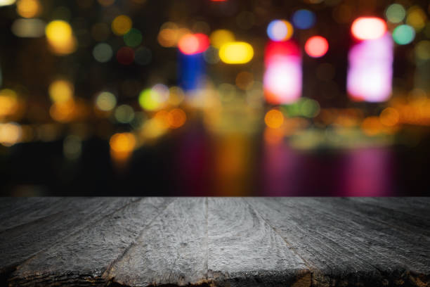 istock Empty wooden table space platform and blurred night city or dining background for product display montage 1490340534
