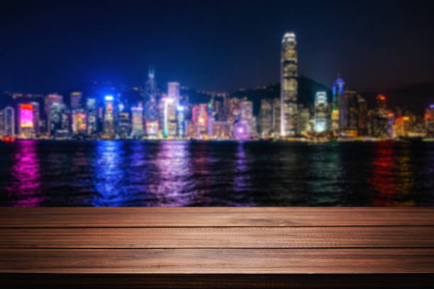 Empty wooden table space platform and blurred night city or dining background for product display montage