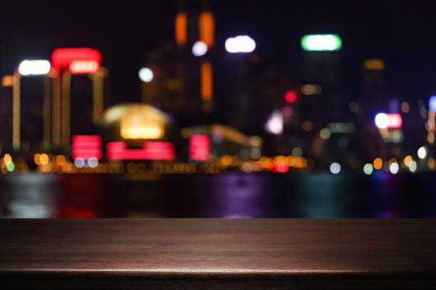 istock Empty wooden table space platform and blurred night city or dining background for product display montage 1490340542
